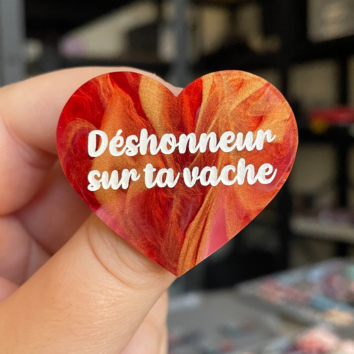 Broche "Déshonneur sur ta vache" en acrylique marbrée rouge, blanche et dorée