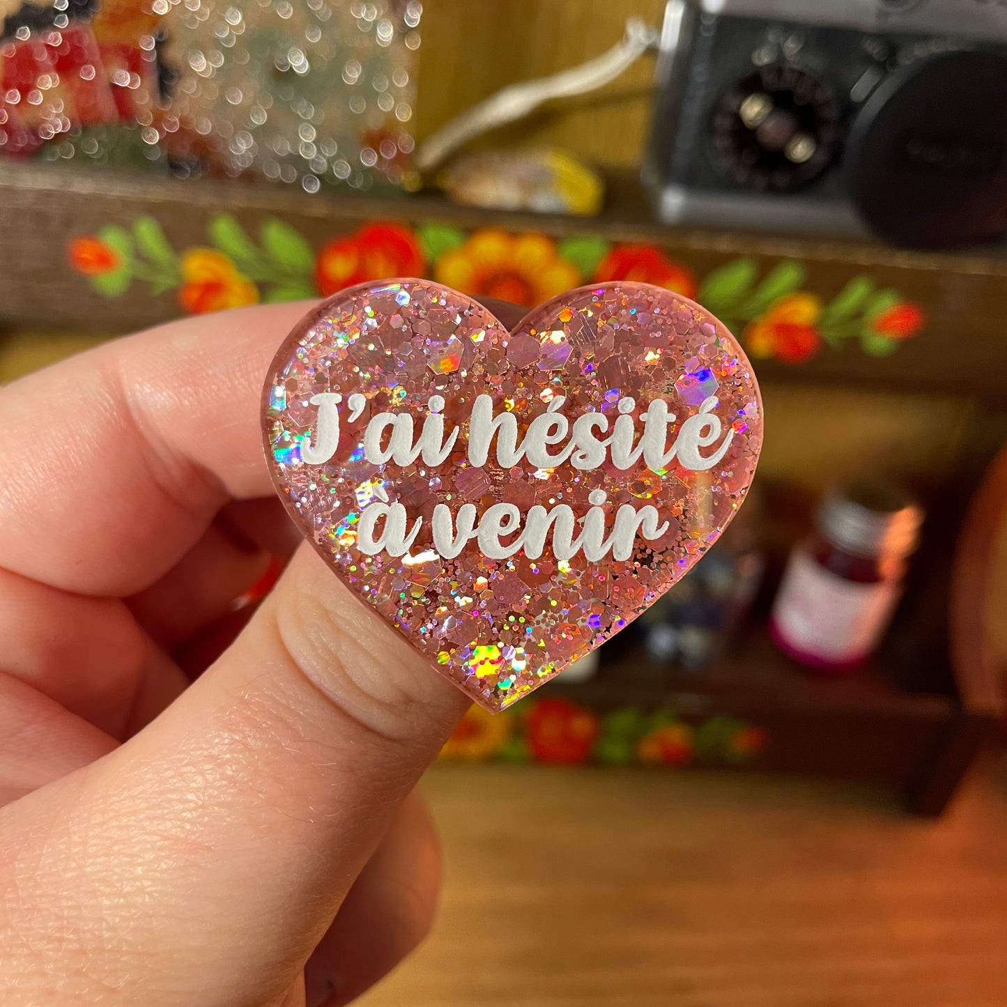 Broche "J'ai hésité à venir" en acrylique semi transparente à paillettes corail