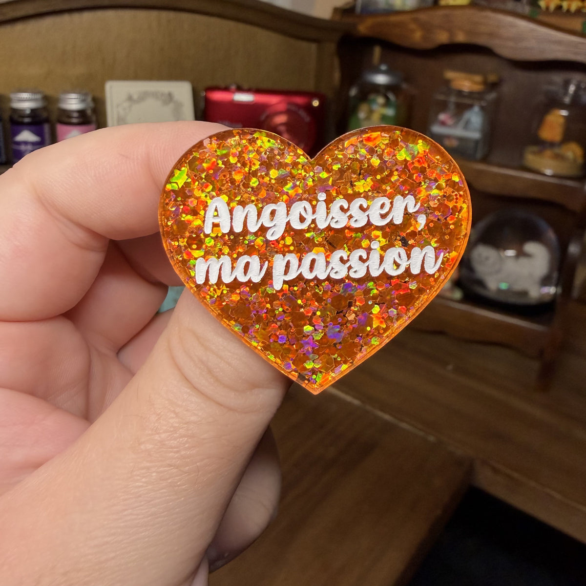 Broche "Angoisser, ma passion" en acrylique à paillettes oranges