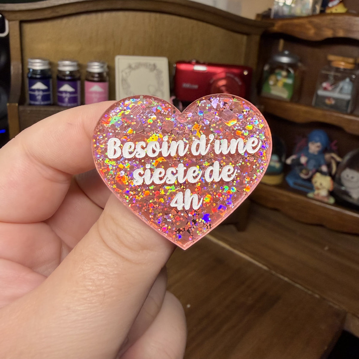 Broche "Besoin d'une sieste de 4h" en acrylique semi transparente avec des paillettes corail