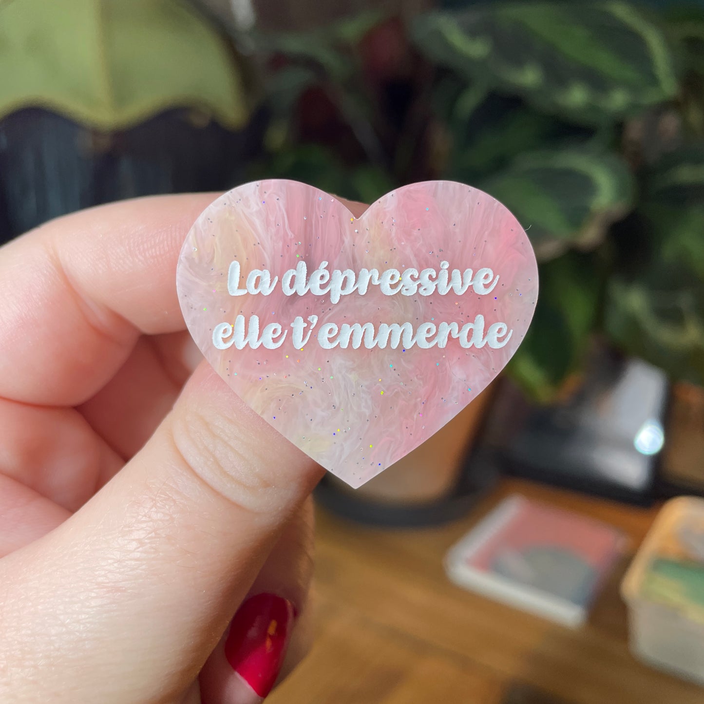 Broche "La dépressive elle t'emmerde" en acrylique marbrée jaune, orange et corail à paillettes
