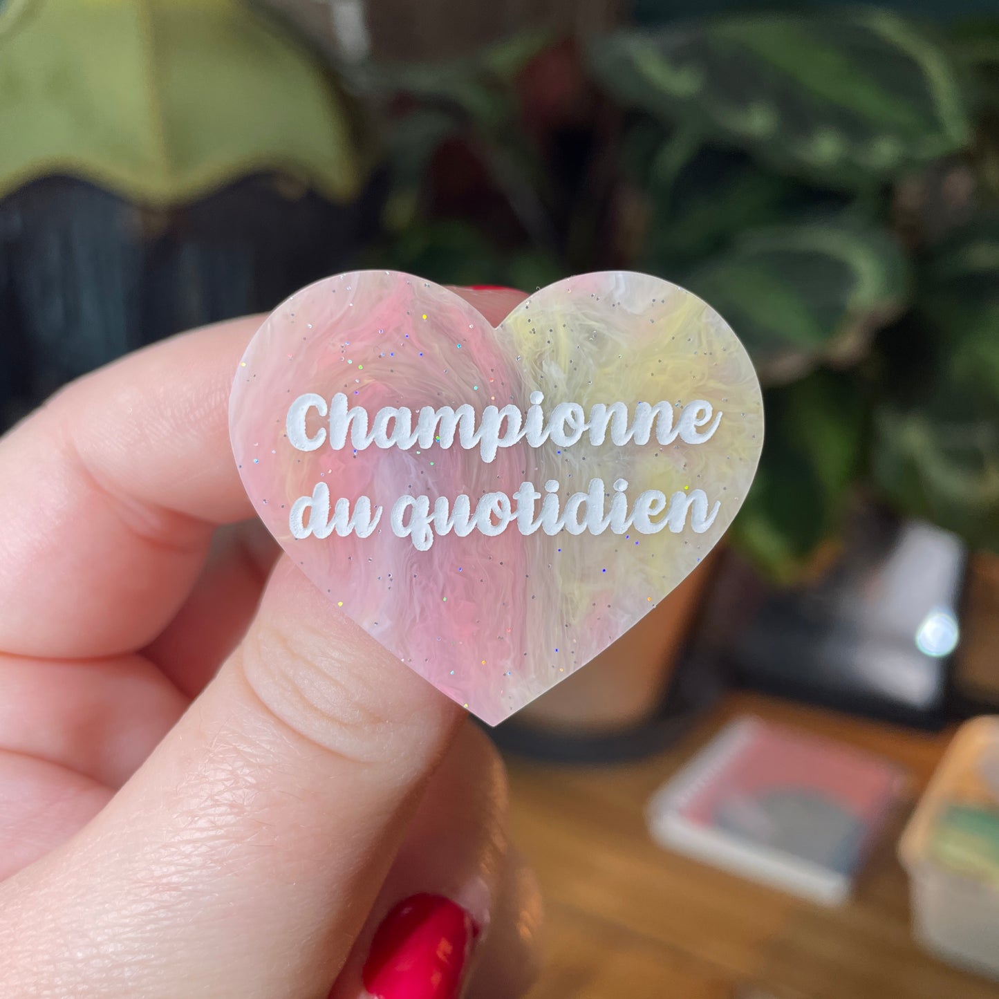 Broche "Championne du quotidien" en acrylique marbrée jaune, orange et corail à paillettes
