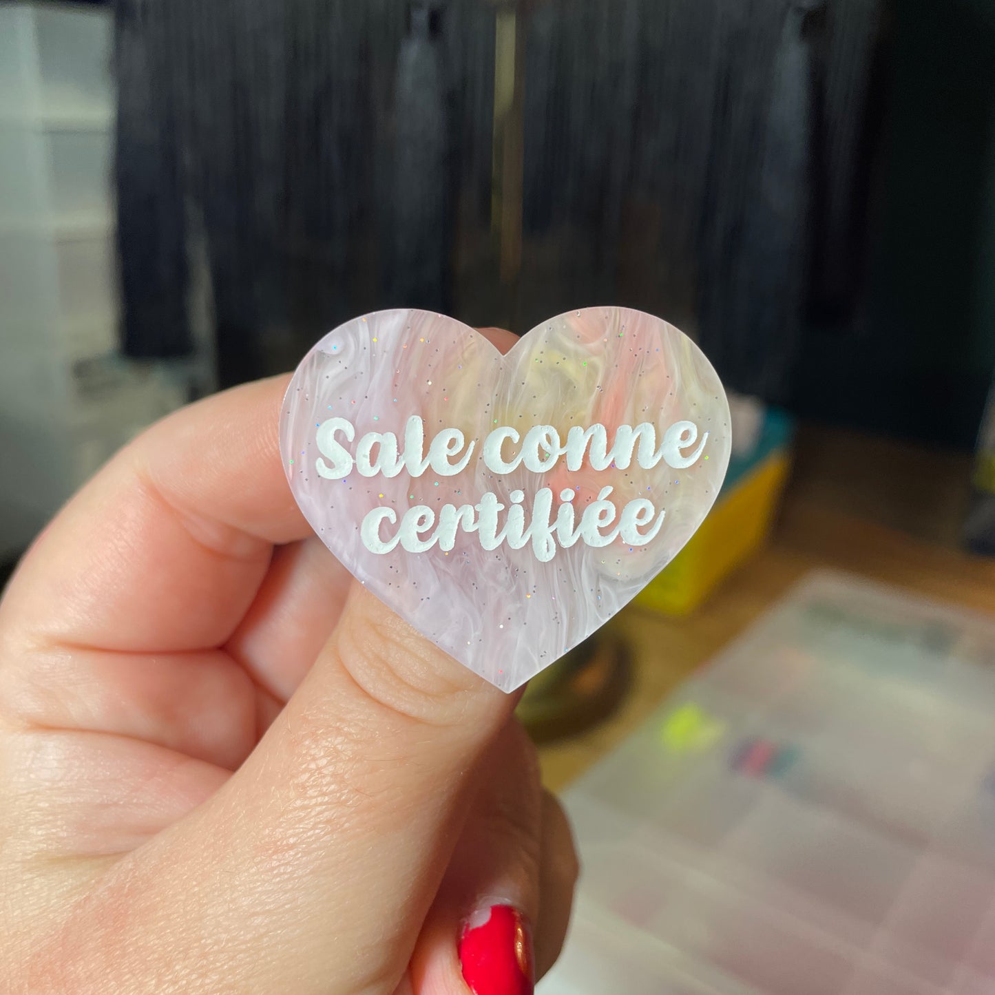 Broche "Sale conne certifiée" en acrylique semi transparente marbrée corail, orange et jaune à paillettes