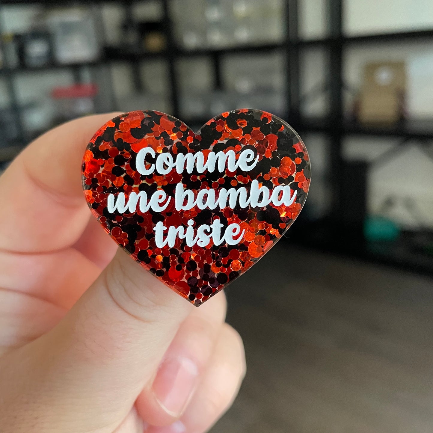 Broche "Comme une bamba triste" en acrylique semi transparente avec des pois rouges et noirs