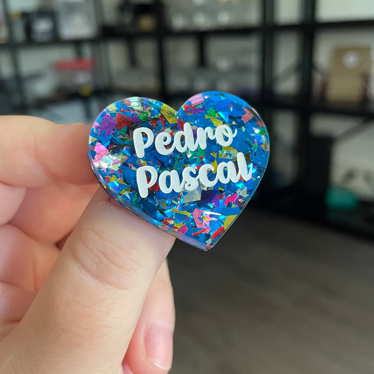 Broche "Pedro Pascal" en acrylique transparente avec des éclats de confettis bleus et multicolores
