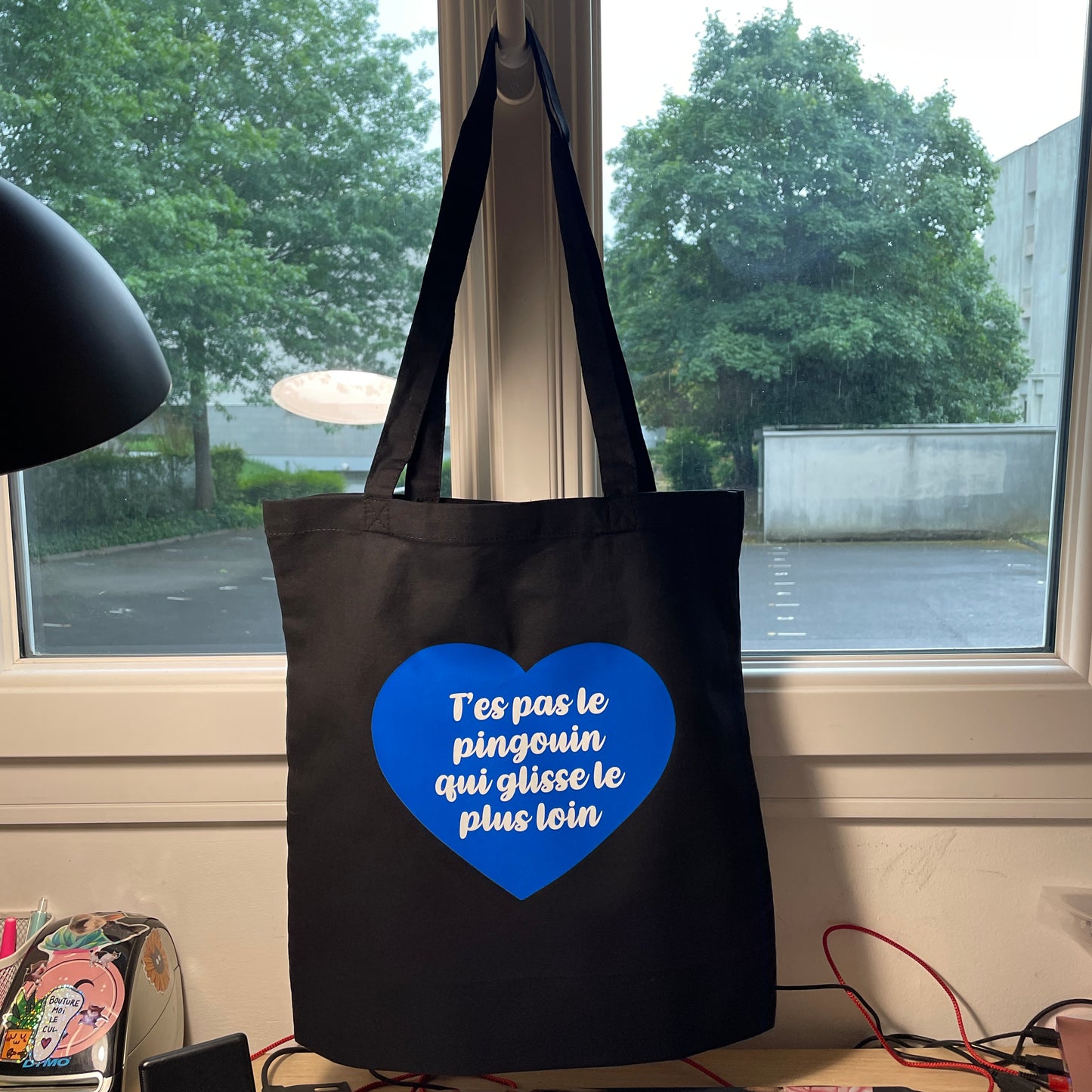 Tote bag en coton noir "T'es pas le pingouin qui glisse le plus loin"