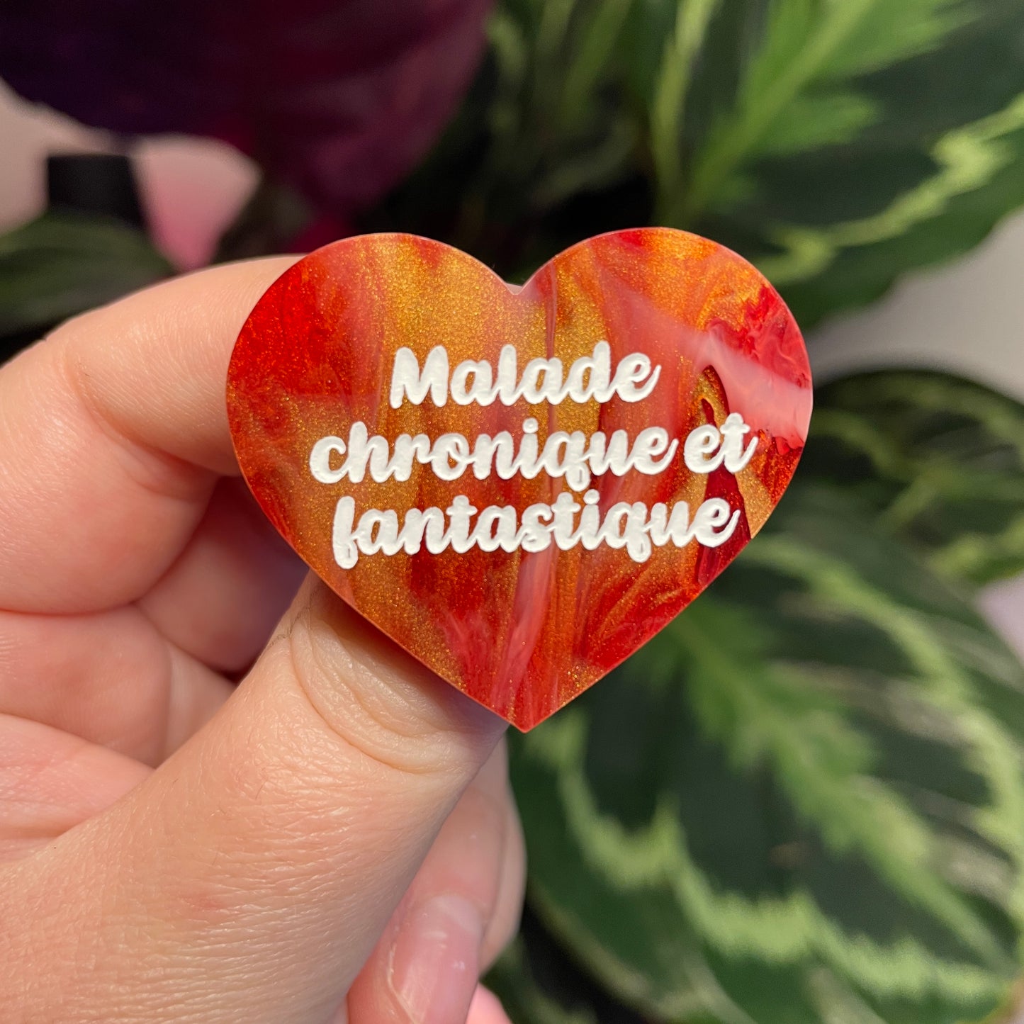Broche "Malade chronique et fantastique" en acrylique marbrée rouge, blanche et dorée