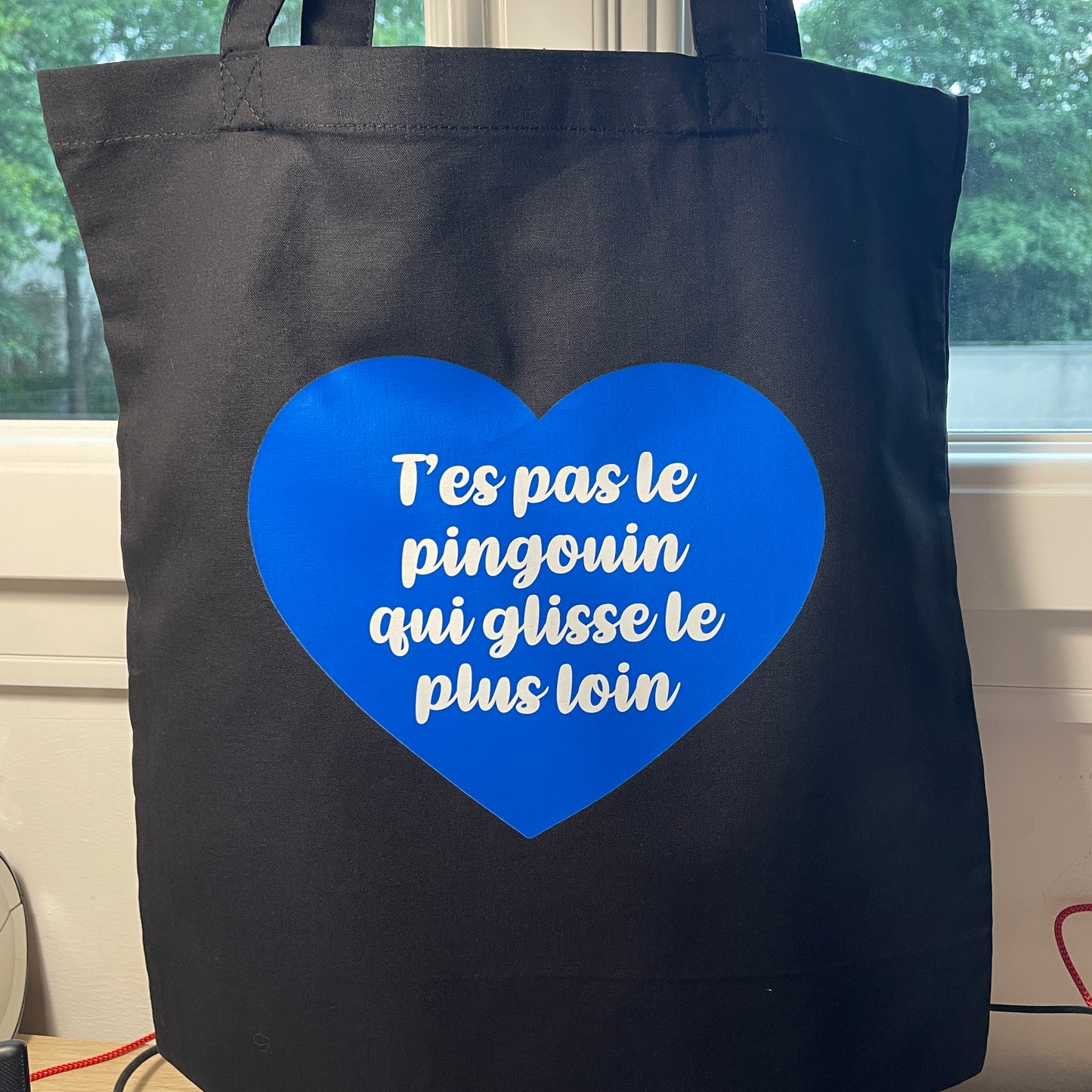 Tote bag en coton noir "T'es pas le pingouin qui glisse le plus loin"