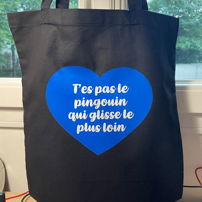 Tote bag en coton noir "T'es pas le pingouin qui glisse le plus loin"