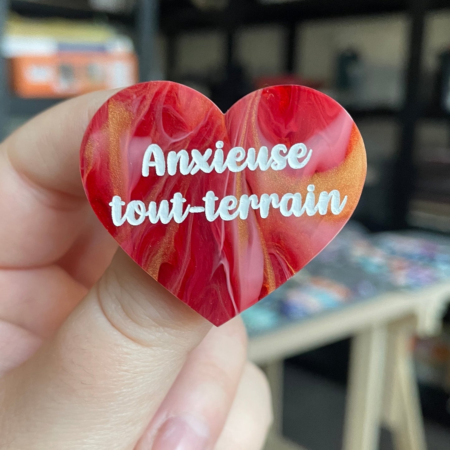 Broche "Anxieuse tout-terrain" en acrylique marbrée rouge, blanche et dorée