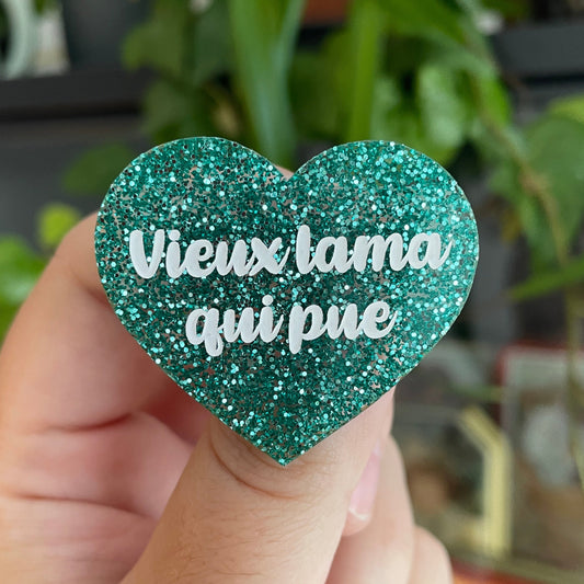 Broche "Vieux lama qui pue" en acrylique à paillettes turquoise