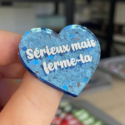 Broche "Sérieux mais ferme-la" en acrylique semi-transparente avec des confettis bleus