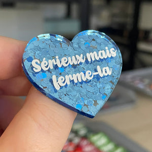 Broche "Sérieux mais ferme-la" en acrylique semi-transparente avec des confettis bleus
