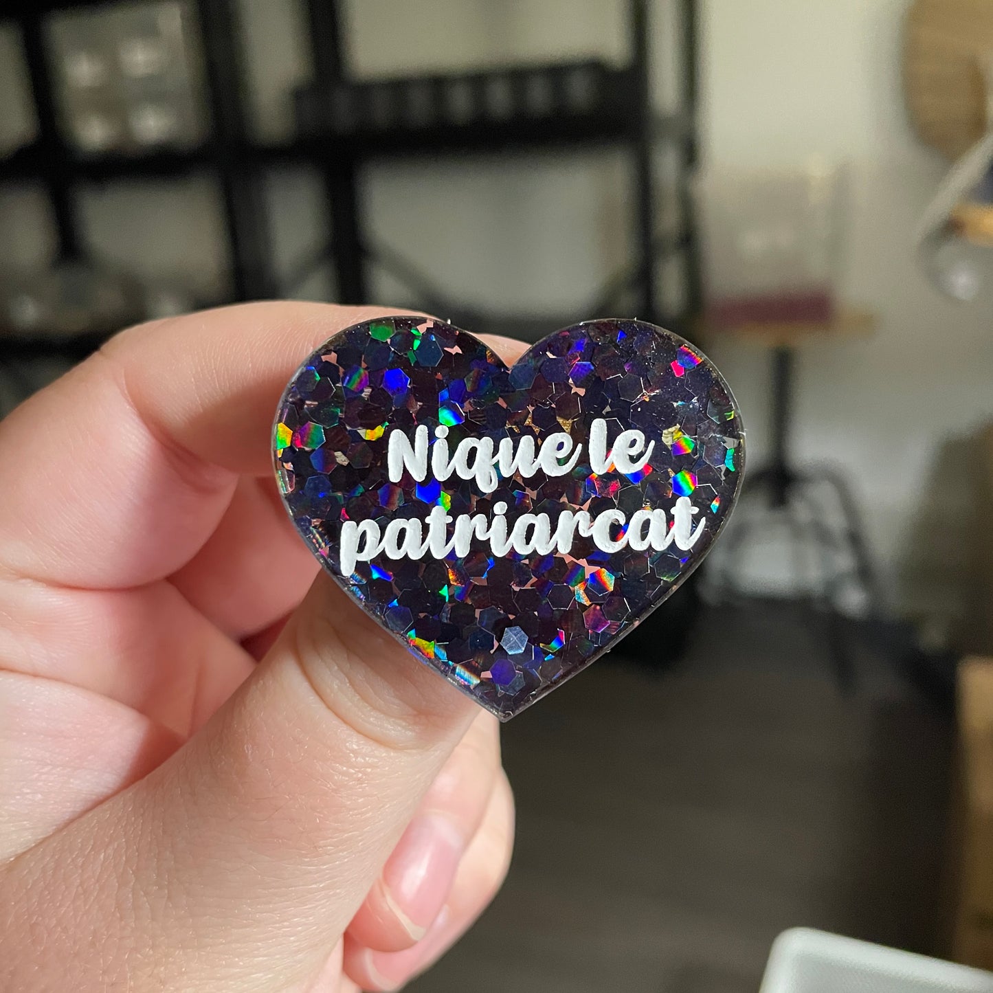[CONTRÔLE TECHNIQUE] Broche "Nique le patriarcat" en acrylique semi transparente avec des confettis noirs