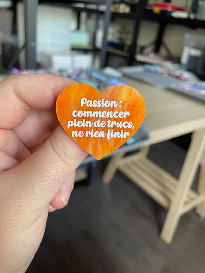 [CONTRÔLE TECHNIQUE] Broche "Passion : commencer plein de trucs, ne rien finir" en acrylique marbrée orange et dorée à paillettes