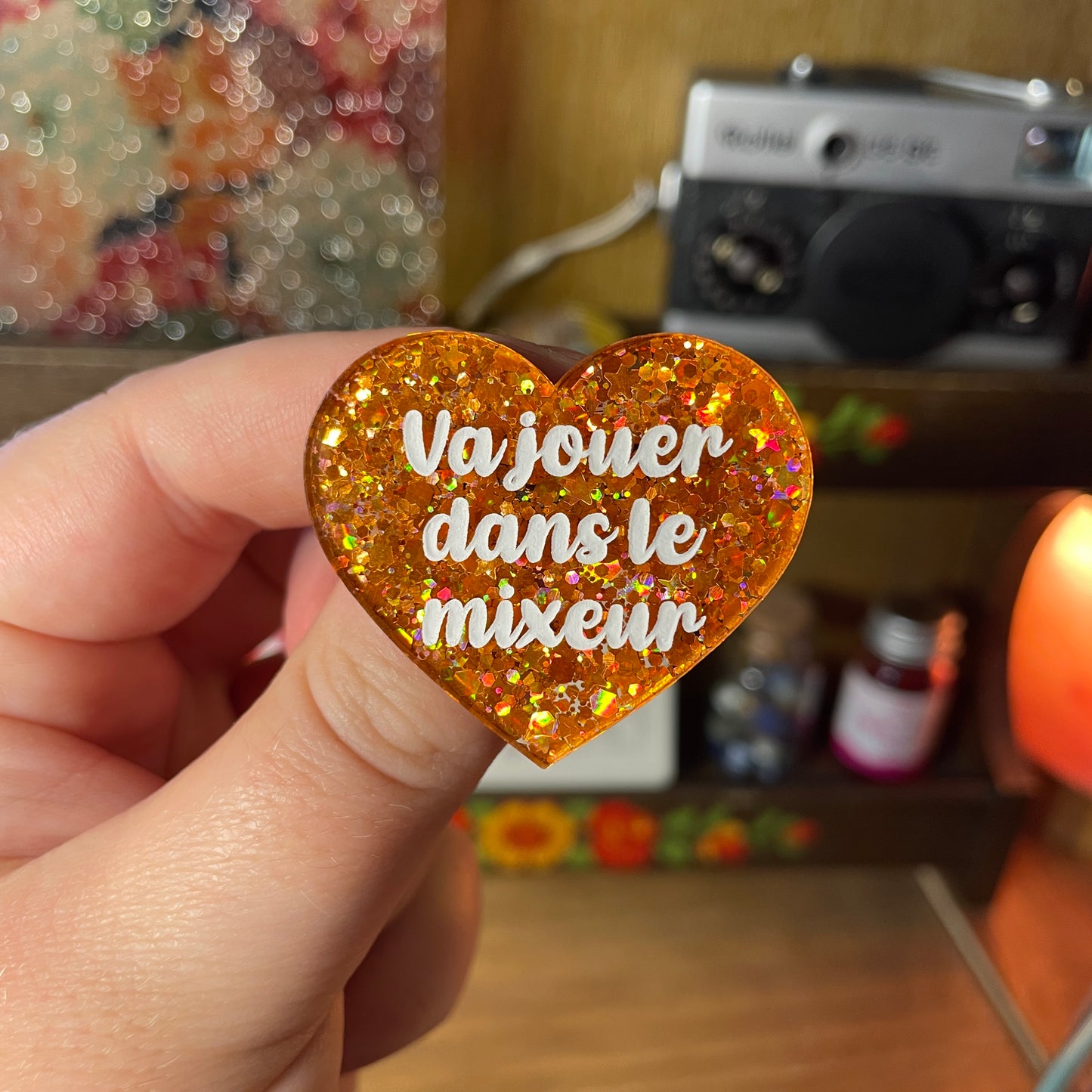 Broche "Va jouer dans le mixeur" en acrylique semi transparente à paillettes oranges