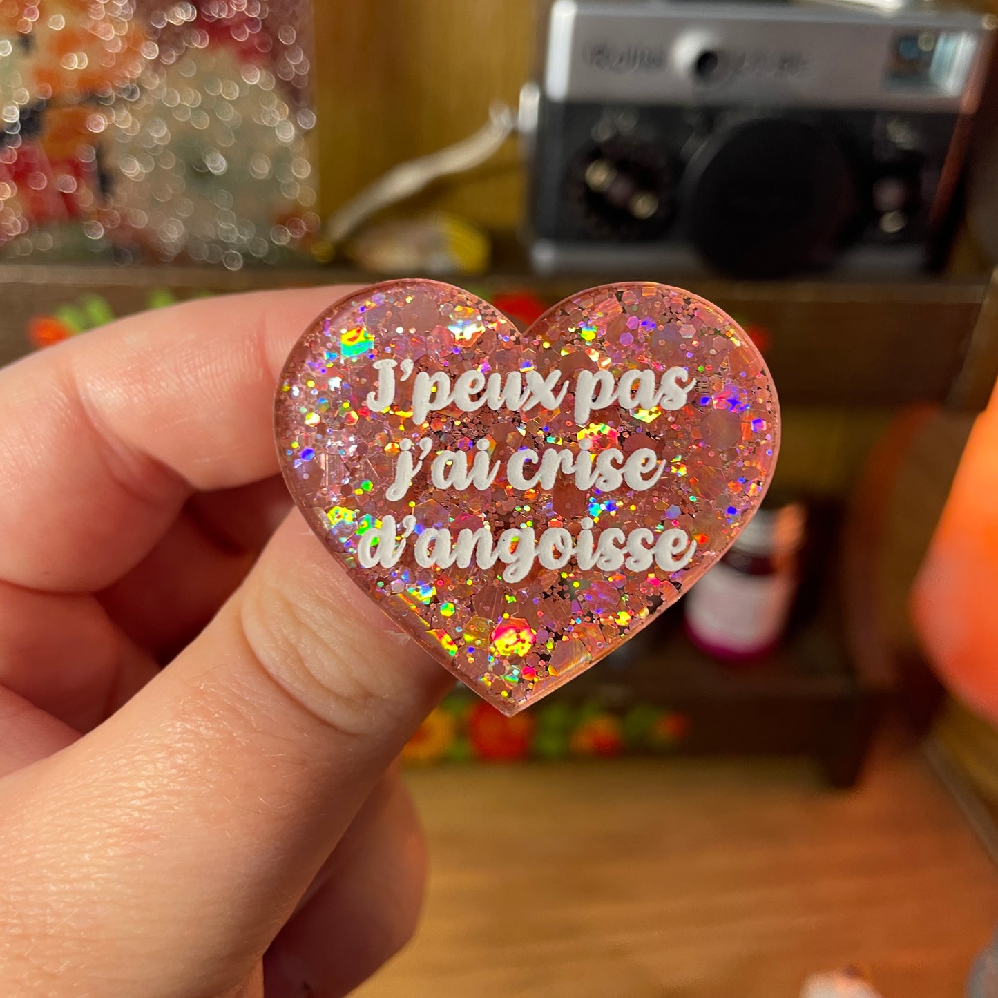 Broche "J'peux pas j'ai crise d'angoisse" en acrylique semi transparente à paillettes corail