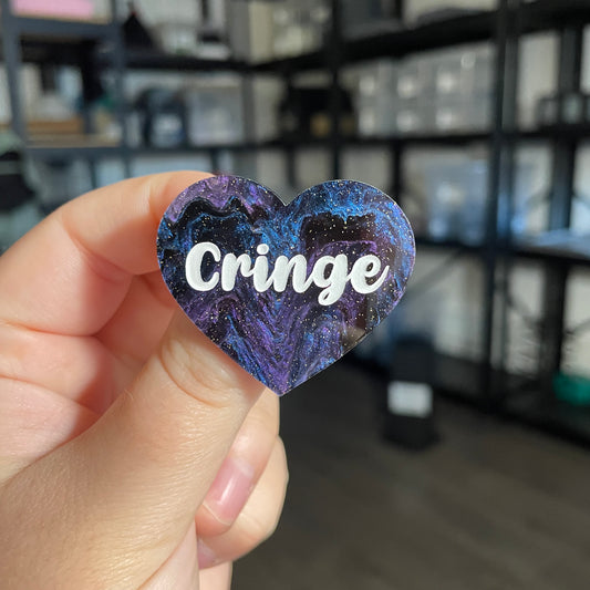 Broche "Cringe" en acrylique marbrée bleue, noire et violette à paillettes