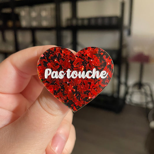 [CONTRÔLE TECHNIQUE] Broche "Pas touche" en acrylique noire avec des éclats de confettis rouges
