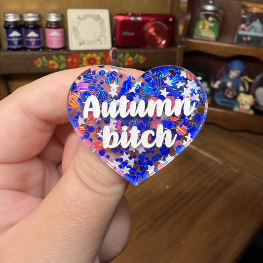 Broche "Autumn bitch" en acrylique semi transparente avec des confettis bleus, roses et blancs