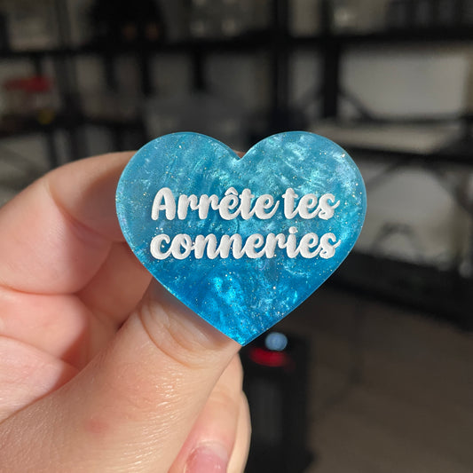 Broche "Arrête tes conneries" en acrylique marbrée bleue à paillettes