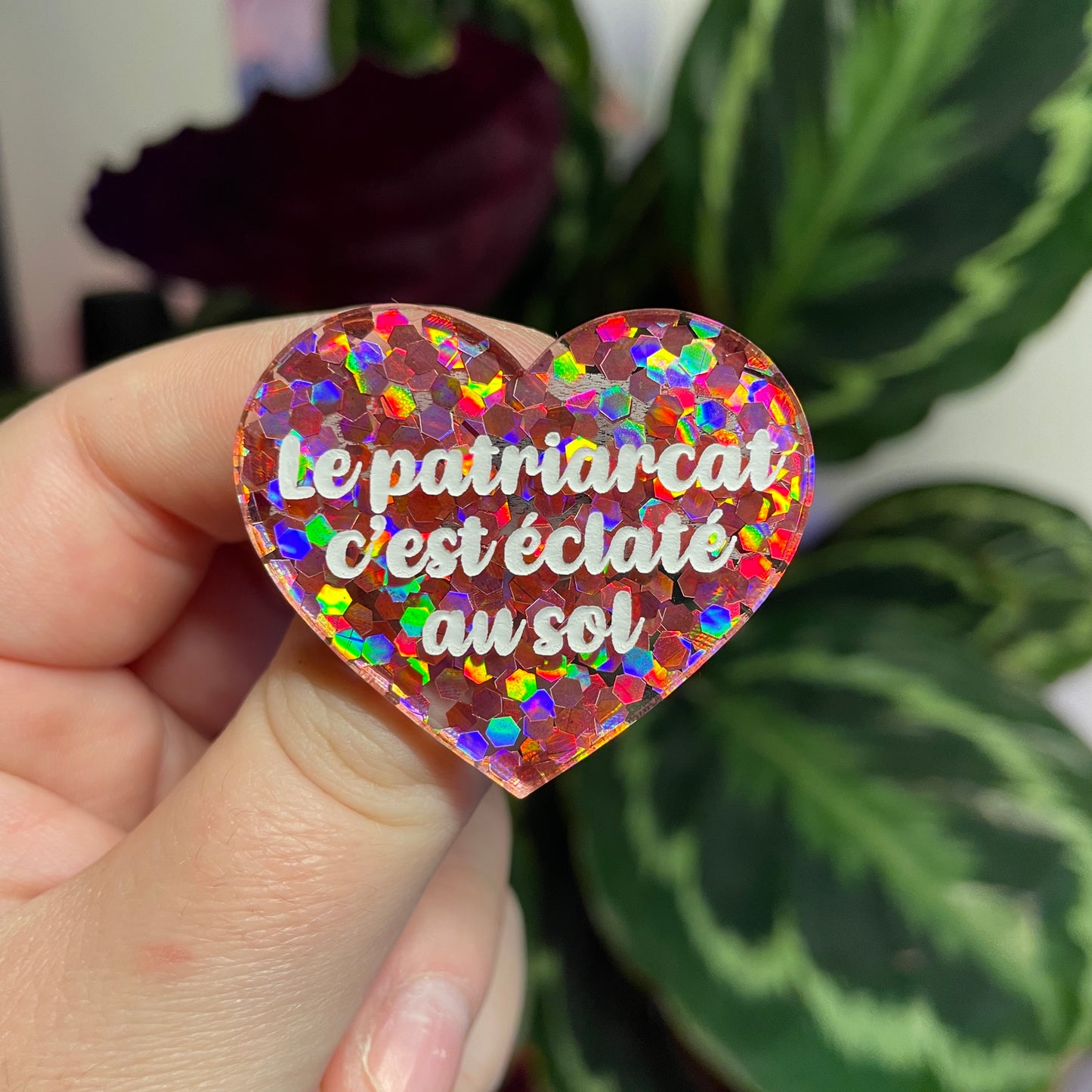Broche "Le patriarcat c'est éclaté au sol" en acrylique semi transparente avec des confettis corail