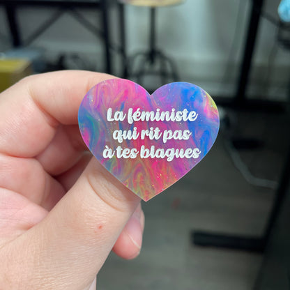 Broche "La féministe qui rit pas à tes blagues" en acrylique semi-transparente marbrée multicolore