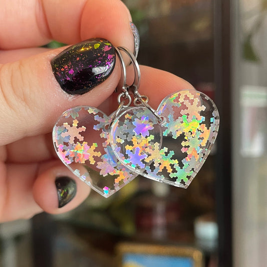 Petites boucles d'oreilles coeurs pendantes en acrylique transparente avec des confettis flocons holographiques