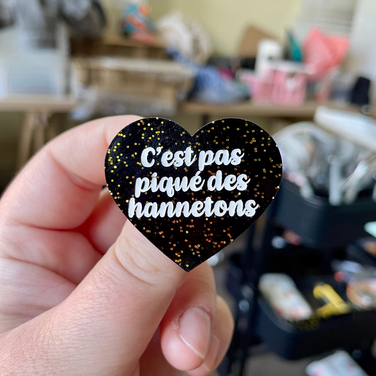 Broche "C'est pas piqué des hannetons" en acrylique noire avec des paillettes dorées