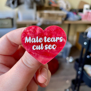 Broche "Male tears cul sec" en acrylique marbrée rose à paillettes