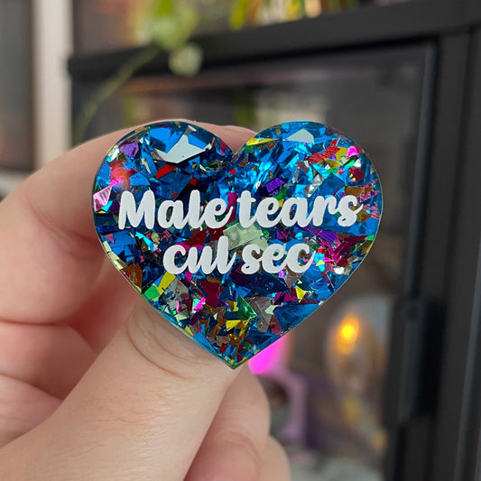 [CONTRÔLE TECHNIQUE] Broche "Male tears cul sec" en acrylique avec des éclats de confettis bleus et multicolores