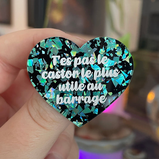 [CONTRÔLE TECHNIQUE] Broche "T'es pas le castor le plus utile au barrage" en acrylique noire avec des éclats de confettis turquoise
