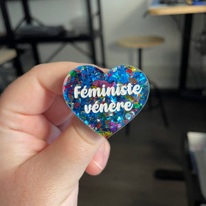 [CONTRÔLE TECHNIQUE] Broche "Féministe vénère" en acrylique transparente avec des gros confettis bleus et multicolores