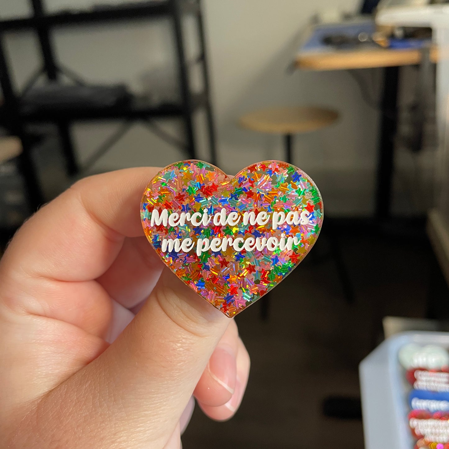 [CONTRÔLE TECHNIQUE] Broche "Merci de ne pas me percevoir" en acrylique semi transparente avec des confettis étoiles multicolores