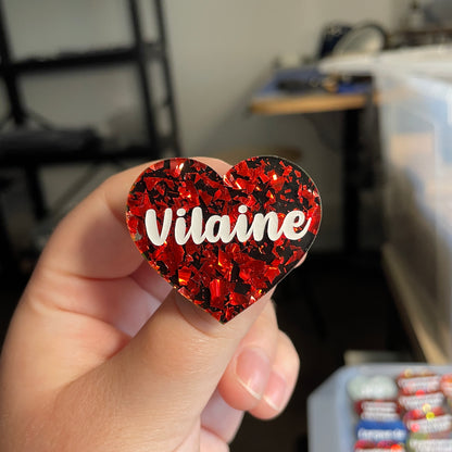 [CONTRÔLE TECHNIQUE] Broche "Vilaine" en acrylique noire avec des éclats de confettis rouges