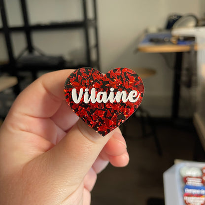 [CONTRÔLE TECHNIQUE] Broche "Vilaine" en acrylique noire avec des éclats de confettis rouges