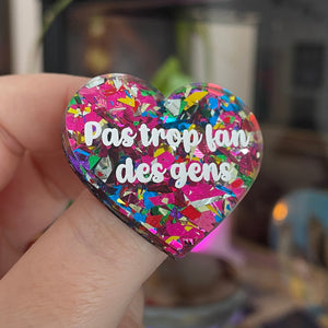 Broche "Pas trop fan des gens" en acrylique avec des éclats de confettis roses et multicolores