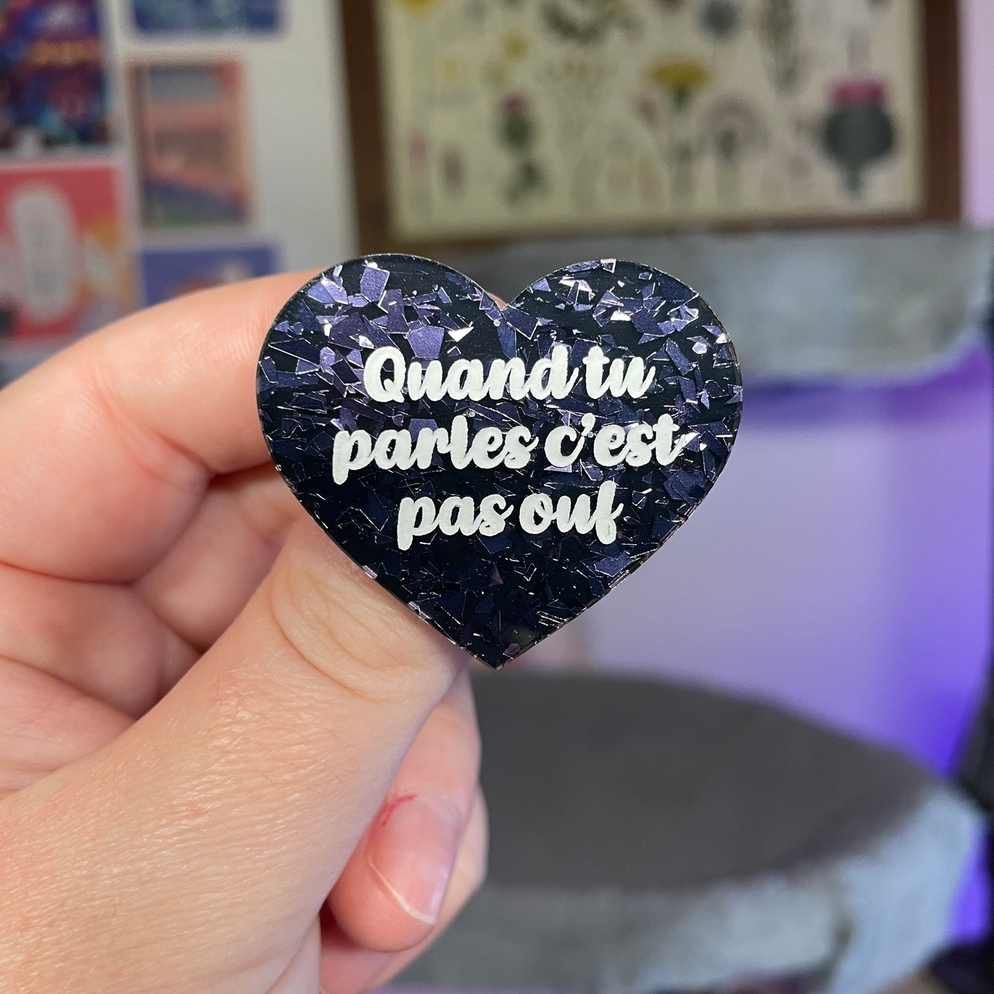Broche "Quand tu parles c'est pas ouf" en acrylique noire avec des éclats de confettis violets