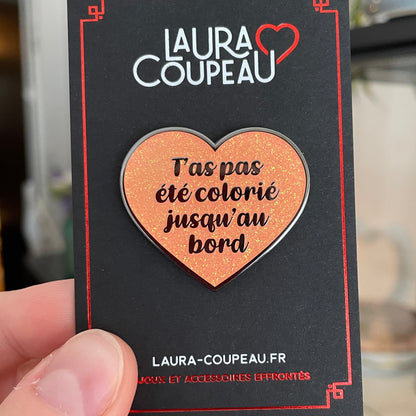 Pin en émail "T'as pas été colorié jusqu'au bord" orange à paillettes