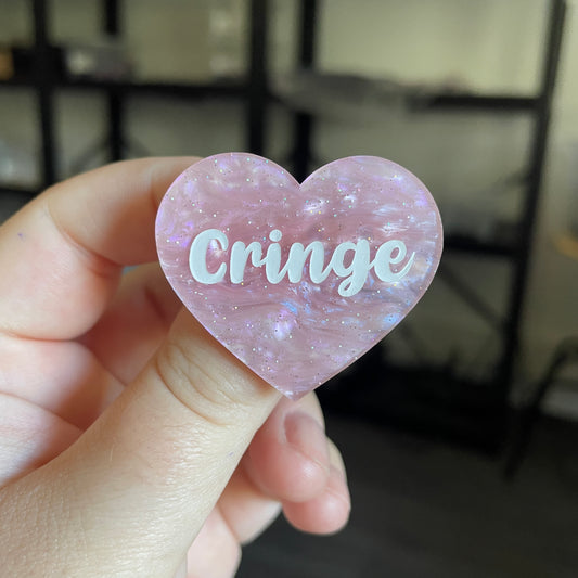 Broche "Cringe" en acrylique marbrée rose pâle à paillettes