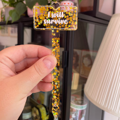 [CONTRÔLE TECHNIQUE] Pic à plante "I will survive" en acrylique transparente avec des paillettes dorées