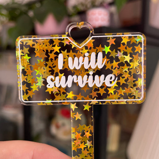 [CONTRÔLE TECHNIQUE] Pic à plante "I will survive" en acrylique transparente avec des paillettes dorées