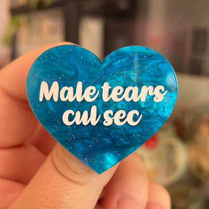 Broche "Male tears cul sec" en acrylique marbrée bleue à paillettes