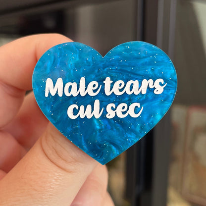 Broche "Male tears cul sec" en acrylique marbrée bleue à paillettes