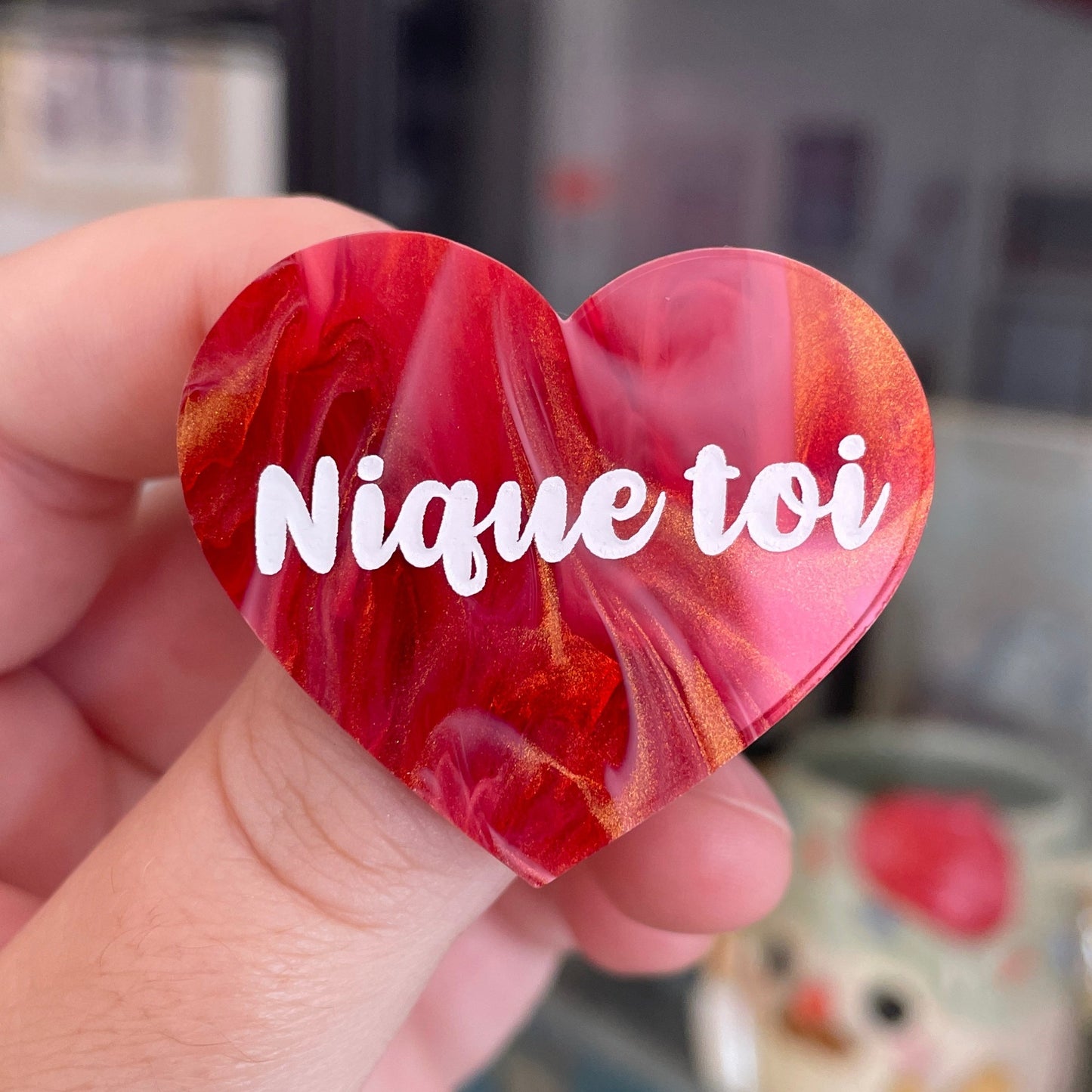 Broche "Nique toi" en acrylique marbrée rouge, blanche et dorée