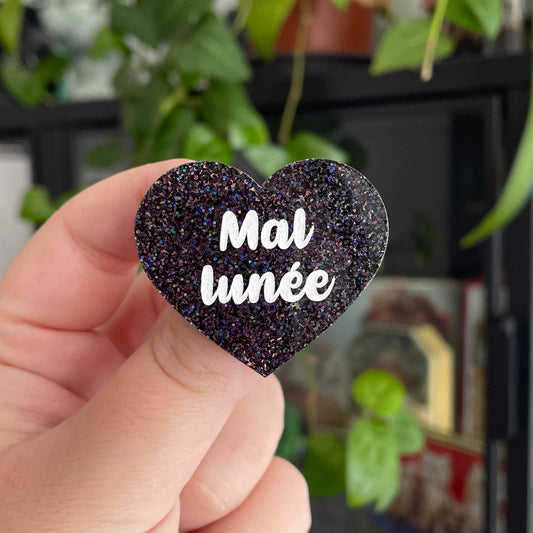 Broche "Mal lunée" en acrylique à paillettes noires holographiques