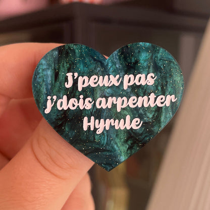 [CONTRÔLE TECHNIQUE] Broche "J'peux pas j'dois arpenter Hyrule" en acrylique marbrée noire et vert sapin