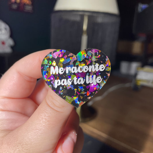 Broche "Me raconte pas ta life" en acrylique noire avec des éclats de confettis multicolores