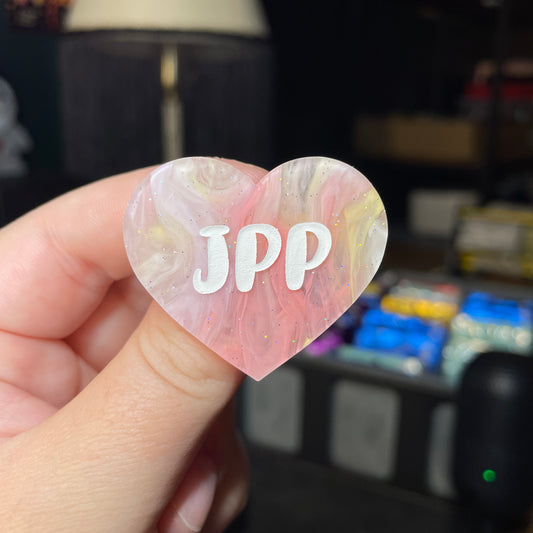 Broche "JPP" en acrylique semi transparente marbrée corail, orange et jaune à paillettes