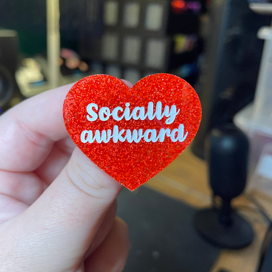 [Contrôle technique] Broche "Socially awkward" en acrylique à paillettes oranges